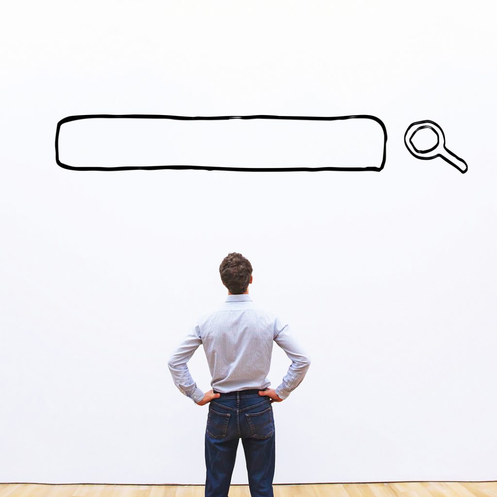 Man contemplating a large search bar graphic, symbolizing effective keyword strategy and SEO for marketing.