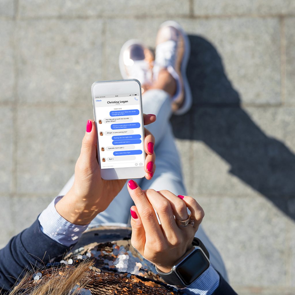 Person holding smartphone displaying Facebook Messenger conversation, showcasing digital communication and social engagement relevant to marketing strategies.