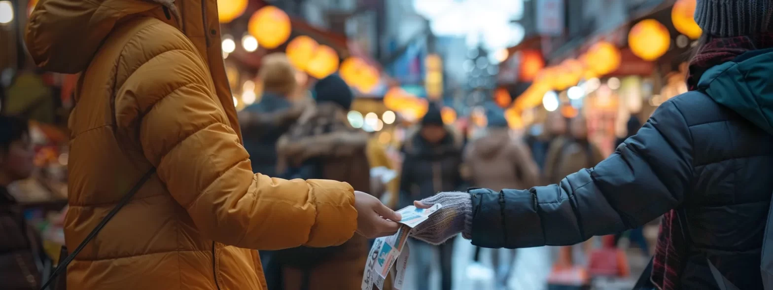 a person handing out flyers to a crowd at a bustling city street market.